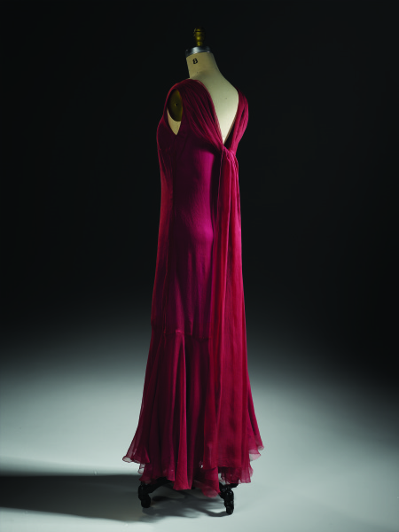 Evening dress, dark red satin with petal capped short sleeves, floating panel at back of dress